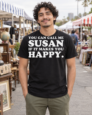 AI-generated lifestyle visualization of a person wearing the You Can Call Me Susan If It Makes You Happy. black tri-blend quote T-shirt in an outdoor flea market