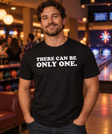 AI-generated lifestyle visualization of an adult wearing the There Can Be Only One black tri-blend quote T-shirt, front artwork visible.