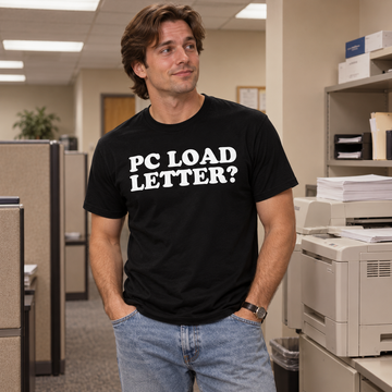 AI-generated lifestyle visualization of a person wearing the black tri-blend PC Load Letter quote T-shirt in a retro office copy room