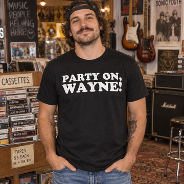 AI-generated lifestyle visualization of a person wearing the black tri-blend Party On, Wayne! quote T-shirt in a retro music shop