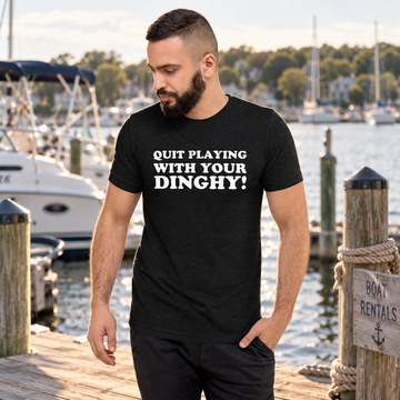 AI-generated marina lifestyle visualization of a man wearing the black tri-blend Quit Playing with Your Dinghy! quote T-shirt