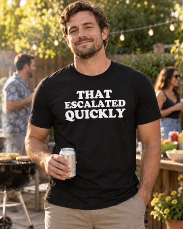 AI-generated lifestyle visualization: person wearing the black tri-blend That Escalated Quickly quote T-shirt at a backyard cookout