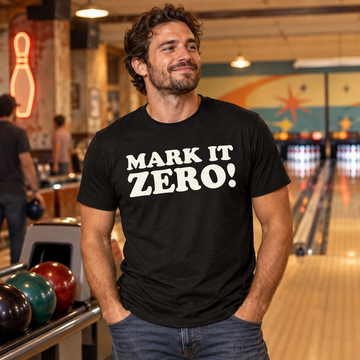 AI-generated lifestyle visualization: person wearing the black tri-blend Mark It Zero! quote T-shirt at a neighborhood bowling alley
