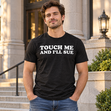 AI-generated lifestyle visualization: person wearing the black tri-blend Touch Me and I'll Sue quote T-shirt outside a courthouse