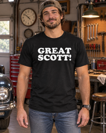 AI-generated lifestyle visualization: person wearing the black tri-blend Great Scott! quote T-shirt in a retro suburban garage workshop with analog clocks, scattered tools, and dramatic practical lighting