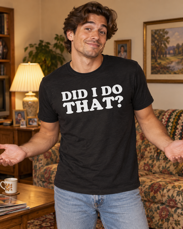 AI-generated lifestyle visualization: person wearing the black tri-blend Did I Do That? quote T-shirt in a warm 1990s family living room with patterned sofa, table lamp, and playful candid energy