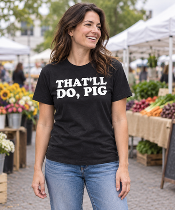 AI-generated lifestyle visualization: person wearing the black tri-blend That'll Do, Pig quote T-shirt at an outdoor market
