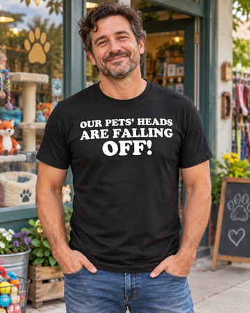 AI-generated lifestyle visualization: person wearing the black tri-blend Our Pets' Heads Are Falling Off! quote T-shirt in a quirky neighborhood pet shop exterior with colorful window displays and bright overcast daylight