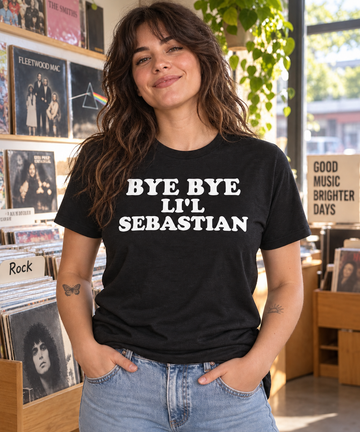 AI-generated lifestyle visualization: person wearing the black tri-blend Bye Bye Li'l Sebastian quote T-shirt in a record shop