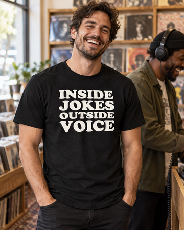 AI-generated lifestyle visualization: person wearing the black tri-blend Inside Jokes Outside Voice Quote Club T-shirt in an independent record shop