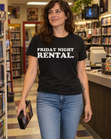 AI-generated lifestyle visualization of a person wearing the Friday Night Rental. black tri-blend quote T-shirt in neighborhood video rental counter with a different adult woman carrying one generic tape case, warm fluorescent light, no visible brands, and the full blank black T-shirt front unobstructed