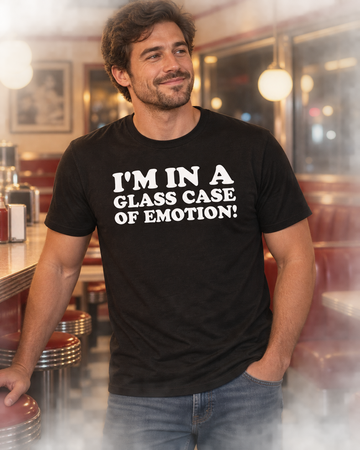 AI-generated lifestyle visualization: person wearing the black tri-blend I'm in a Glass Case of Emotion quote T-shirt in a retro diner