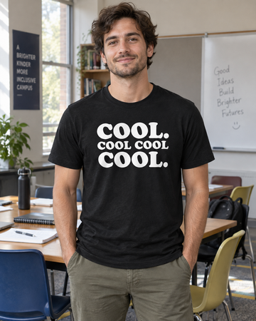 AI-generated lifestyle visualization: person wearing the black tri-blend Cool. Cool Cool Cool. quote T-shirt in a community-college study room with mismatched chairs, notebooks, and soft institutional daylight