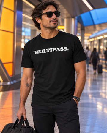 AI-generated lifestyle visualization: person wearing the black tri-blend Multipass. quote T-shirt in retro-futurist transit terminal with bold colored wayfinding panels and no recognizable franchise imagery