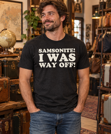 AI-generated lifestyle visualization: person wearing the black tri-blend Samsonite! I Was Way Off! quote T-shirt in a vintage travel-goods shop