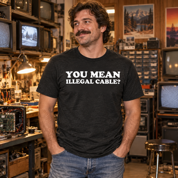 AI-generated lifestyle visualization: person wearing the black tri-blend You Mean Illegal Cable? quote T-shirt in a vintage television repair shop