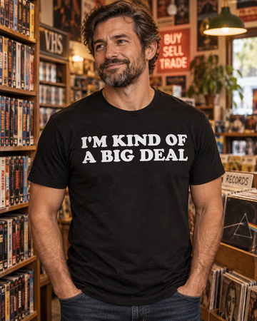 AI-generated lifestyle visualization: person wearing the black tri-blend I'm Kind of a Big Deal quote T-shirt in an independent video and record shop