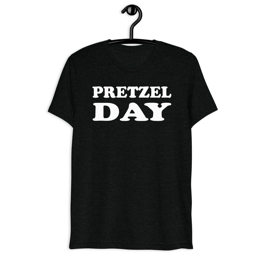 Front hanger mockup of the black tri-blend Pretzel Day quote T-shirt