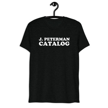 J. Peterman Retro Sitcom Quote T-Shirt on black tri-blend, front hanger view