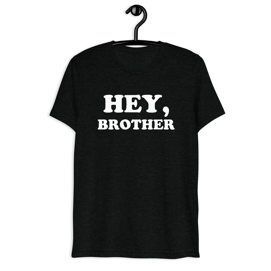 Front hanger mockup of black tri-blend T-shirt with Hey, Brother quote in white vintage lettering