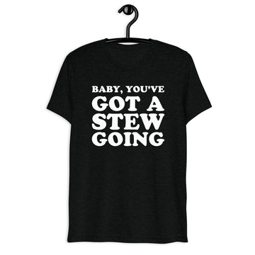 Front hanger mockup of the black tri-blend Baby, You've Got a Stew Going quote T-shirt