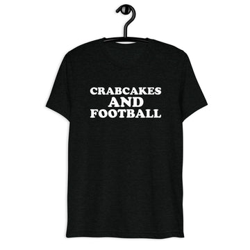 Front hanger view of black tri-blend quote shirt reading Crabcakes and Football