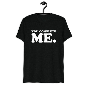 Front hanger view of black tri-blend quote shirt reading You Complete Me.