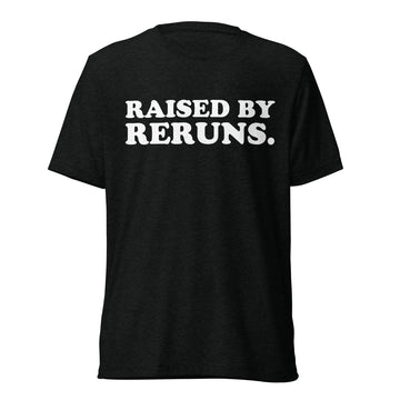 Front hanger view of black tri-blend quote shirt reading Raised by Reruns.