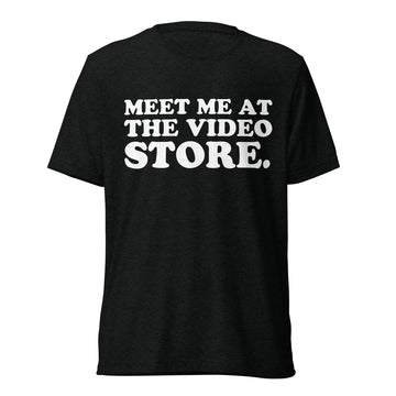 Front hanger view of black tri-blend quote shirt reading Meet Me at the Video Store.