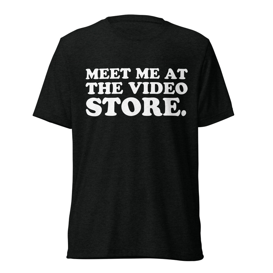 Front hanger view of black tri-blend quote shirt reading Meet Me at the Video Store.