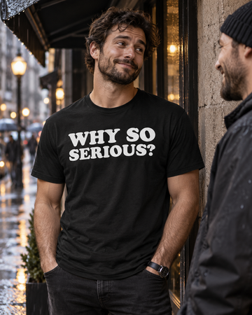 AI-generated lifestyle visualization: person wearing the black tri-blend Why So Serious? quote T-shirt in a rainy downtown side street with concrete walls and moody practical city light